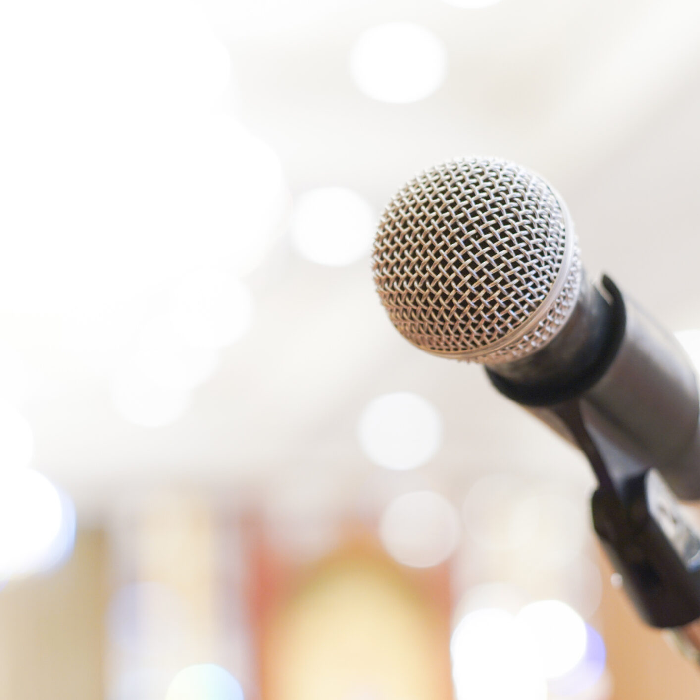 Microphone over the abstract blurred conference hall room business seminar